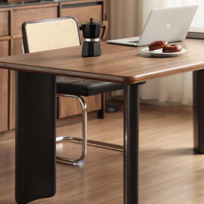 Osta large dining table in black walnut, close-up detail of leg and underside construction
