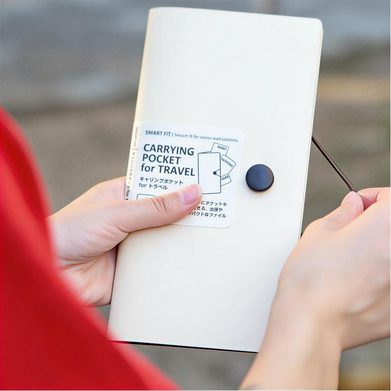 Portable folder in cream, lifestyle shot showing the folder held in hands outdoors