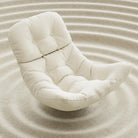 Close-up of the Edie rocking chair's soft beige chenille fabric showing the plush texture and quilted detailing