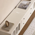 Emily TV console in white with items displayed on top surface in a French-style living room setting