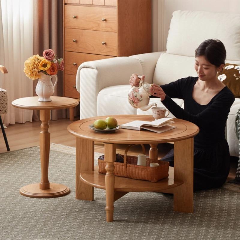 Person seated beside the Fayth nesting table set in a living room setting