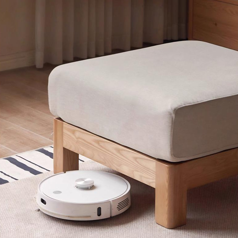 Beige Japandi solid wood sofa ottoman with elevated legs, showing clearance underneath for robot vacuum