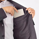 Portable folder in cream, lifestyle shot showing the folder slipped into a jacket pocket