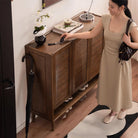 Vivian shoe rack styled in a home entryway with decor on top surface and shoes on bottom shelf