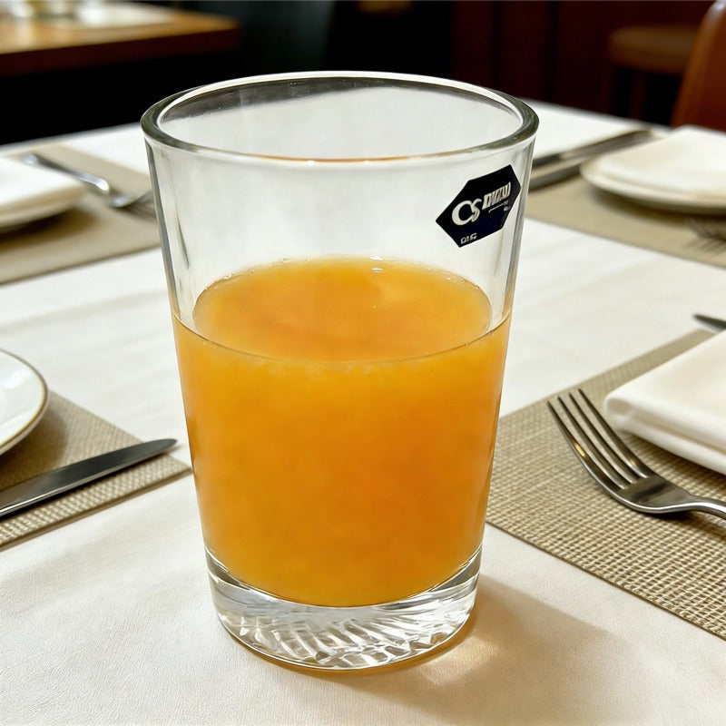 Whiskey glass 290ml, lifestyle shot showing the glass filled with juice on a set table