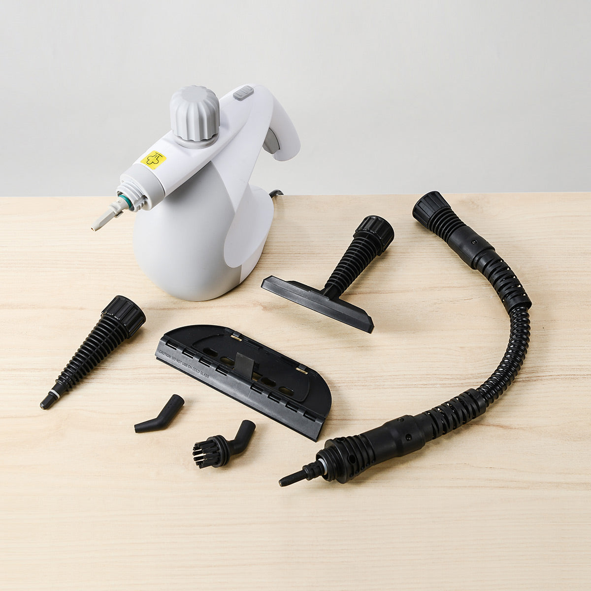 IUIGA handheld steam cleaner in grey, with attachments